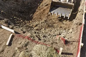 Pool Installation Process Prints: Small bulldozer digging in yard for pool installation