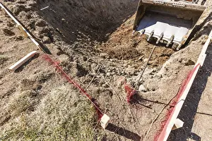 Pool Installation Process Prints: Small bulldozer digging in yard for pool installation