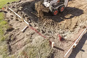 Bulldozer Construction Site Prints: Small bulldozer digging in yard for pool installation