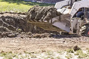 Pool Installation Prints: Small bulldozer digging in yard for pool installation