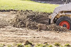 Bulldozer Construction Site Prints: Small bulldozer digging in yard for pool installation