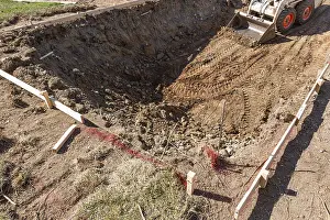 Bulldozer Construction Site Prints: Small bulldozer digging in yard for pool installation
