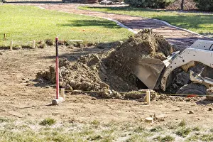 Swimming Pool Building Process Prints: Small bulldozer digging in yard for pool installation