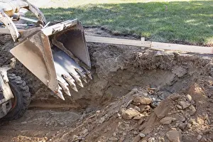 Bulldozer Construction Site Prints: Small bulldozer digging in yard for pool installation
