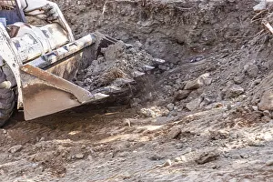 Construction Site Equipment Prints: Small bulldozer digging in yard for pool installation