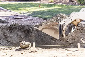 Bulldozer Construction Site Prints: Small bulldozer digging in yard for pool installation