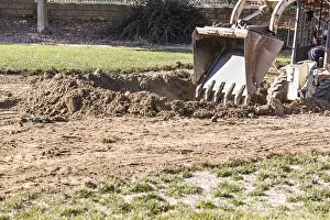 Bulldozer Construction Site Prints: Small bulldozer digging in yard for pool installation