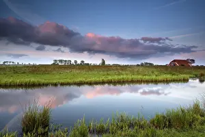 Groningen Prints: Small House by River at Dramatic Pink Sunset Print
