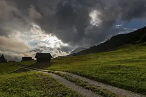 German Mountain Range Views Prints: Small hut on mountain meadow with path and dramatic cloud sky