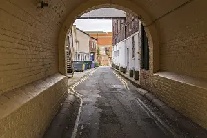 Northern Europe Streets Prints: A small road with garbage containers on the side