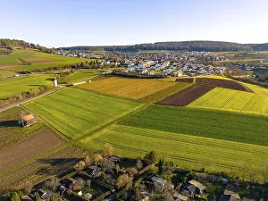 Evening Atmosphere Europe Prints: Small village with fields in the evening light