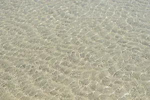 German North Sea Island Prints: Small waves on sandy beach with light reflections