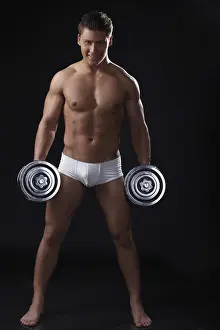 Fitness Studio Shot Prints: Smiling heavyweight posing with rods in studio