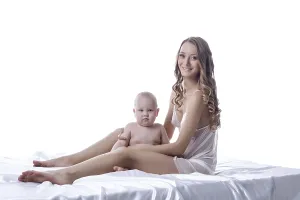 Mother And Son Prints: Smiling lovely model posing with her son in studio
