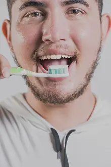Adult Dental Care Prints: Smiling man brushing teeth isolated
