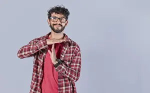 Young Man Smiling Prints: Smiling man gesturing time out isolated