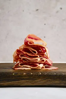 Smoked Food Images Prints: Smoked bacon pieces stacked in a stack