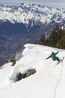 Mountainous Winter Scenery Prints: Two snowboarders skillfully navigate a steep