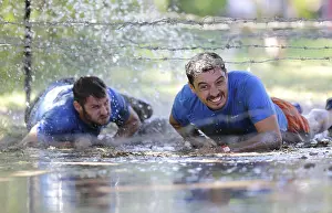 Prints of Sofia, Bulgaria - July 9, 2016: Participants are crawling through water under electrified wires at the Legion Run extreme sport challenge near Sofia Sport Prints: Legion Run Extreme Sport Challenge Print
