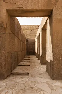 Female Figure Mythology Prints: Solid stone columns and pillars underneath the statue of the Sphinx by Pyramids of Giza in Cairo Egypt