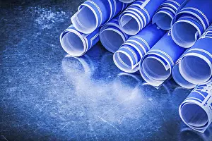 Close Up Construction Plan Prints: Stack of blue engineering drawings on metallic background construction concept
