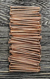 Close Up Detail Prints: Stack of copper nails on wooden board