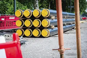 Construction Site Düsseldorf Prints: A stack of district heating pipes on a construction site in Dusseldorf