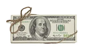 Isolated Dollar Bills Prints: Stack of one hundred dollar bills tied in a burlap string isolated on a white background