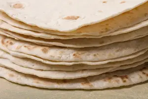 High Angle Food Photography Prints: A stack of Mexican tortillas, on a gray table
