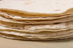 Deserted Table Setup Prints: A stack of Mexican tortillas, on a gray table