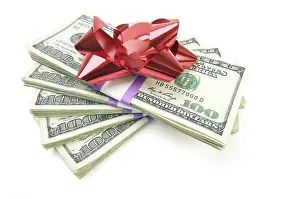 Plain Colored Background Stock Photo Prints: Stack of money with bow isolated on a white background