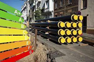 Energy Efficiency Classes Prints: A stack of new pipes for district heating at a construction site
