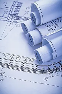 Construction Plan Drawing Prints: Stack of rolls blueprints close up