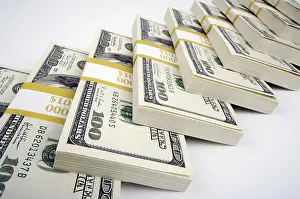 US Dollar Note Prints: Stacks of hundred dollar bills on a white background