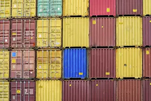 Container Terminal Prints: Standard shipping container in a container terminal in front of loading onto a container ship