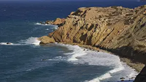 Greek Islands Landscape Prints: Steep cliffs with rolling waves under a clear sky