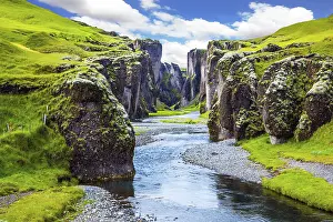 Eroded Rock Formation Prints: Steep vertical cliffs surround the stream of very cold water