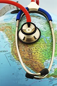 Prints of A stethoscope on a globe showing America. Austria Map Prints: A Stethoscope on a Globe Showing America and Austria Print