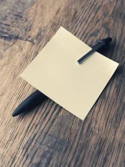 Office Stationery Prints: Sticky note with a pen on a table