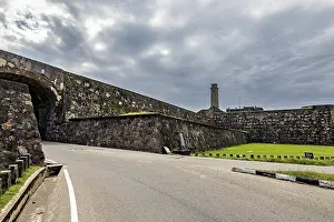 Sri Lankan Architecture Prints: Stone wall along a road under a dramatic cloudy sky