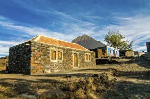 Deserted Volcanic Island Prints: Stonehouse with vulcano in background