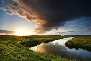 Cloudy Evening Sky Prints: Storm cloud at dramatic sunset in summertime
