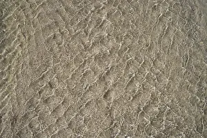 Icelandic Beach Prints: Stream flows at low tide over sandy beach