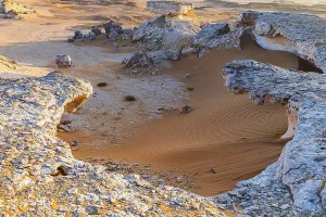 Oman Desert Landscape Prints: Striking cliffs surrounded by windswept sand structures
