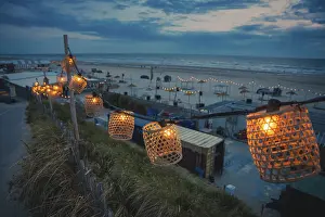 Deserted Dutch Coastline Prints: String of lights on the beach at blue hour