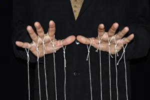 Studio Photography Black Background Prints: String-pulling puppeteer, studio photography with black background