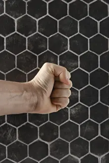 Artistic Expression Prints: A strong fist is positioned in front of a textured hexagonal pattern