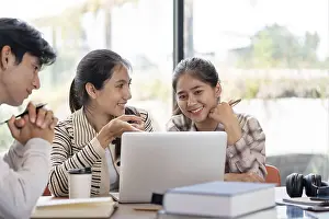 Classroom Interior Photo Prints: Three students working together on a laptop