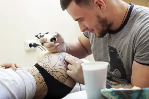 Professional Tattooist Prints: Studio shot of bearded tattoo master at work