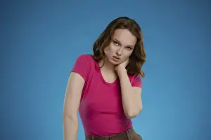 Confident Woman Pose Prints: In a studio with a striking blue background